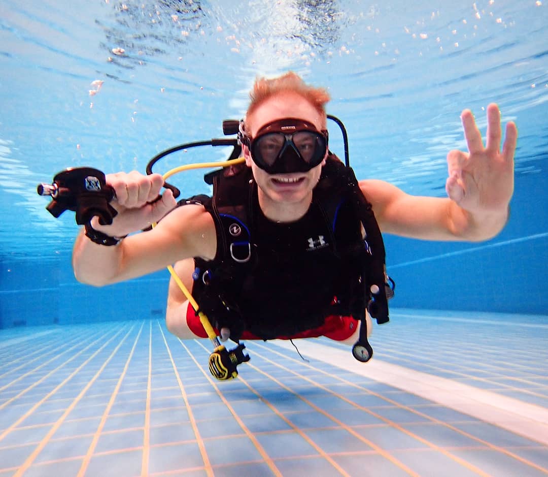 Dive instructor diving in pool